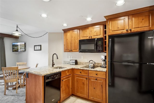 640 Village Rd Unit 4326, Breckenridge, CO 80424 - kitchen with a peninsula, brown cabinetry, a sink, and black appliances