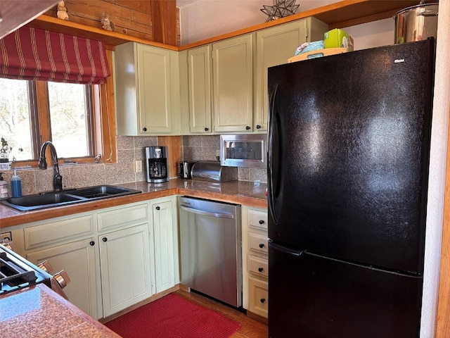2180 Val Disere Cir, Steamboat Springs, CO 80487 - kitchen with freestanding refrigerator, stainless steel dishwasher, decorative backsplash, and a sink