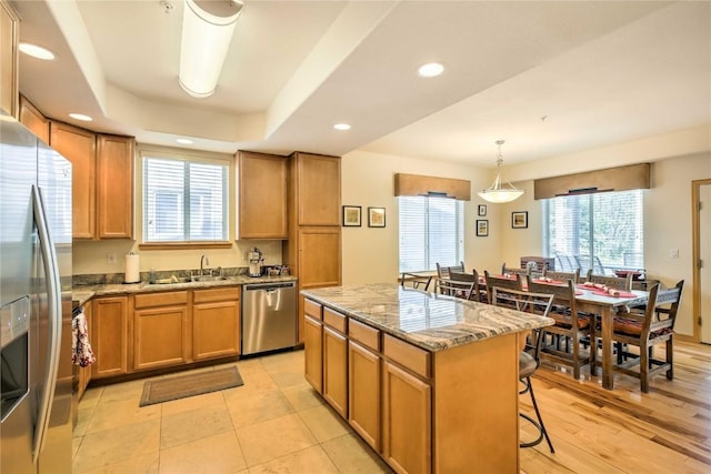 233 Creekside Dr Unit 104, Frisco, CO 80443 - kitchen featuring a wealth of natural light, a kitchen island, a breakfast bar area, and appliances with stainless steel finishes