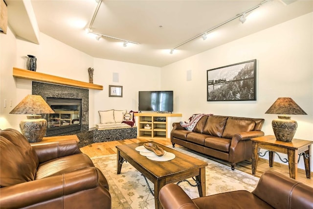 233 Creekside Dr Unit 104, Frisco, CO 80443 - living area with track lighting, a tiled fireplace, and wood finished floors