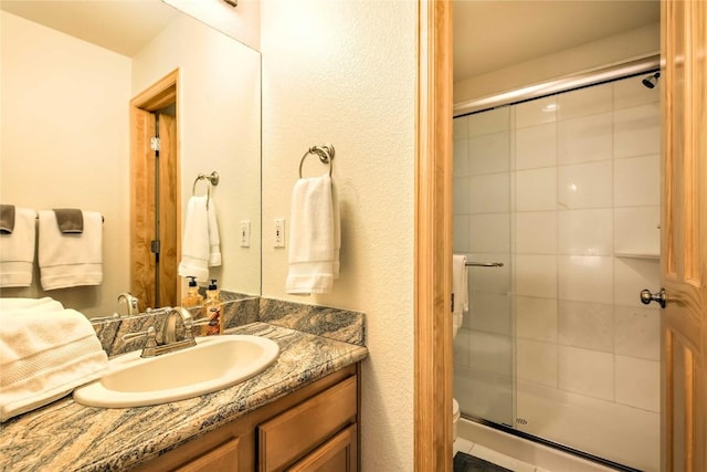 233 Creekside Dr Unit 104, Frisco, CO 80443 - bathroom with a shower stall, vanity, and toilet