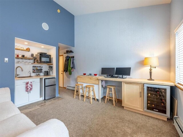 233 Creekside Dr Unit 104, Frisco, CO 80443 - office area with bar with sink, baseboard heating, a baseboard heating unit, beverage cooler, and high vaulted ceiling