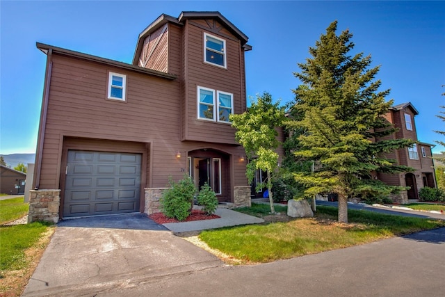 74 Stag Trl Unit 74, Dillon, CO 80435 - townhome / multi-family property featuring stone siding, a garage, and driveway