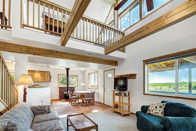 103 Foxtail Ct, Fairplay, CO 80440 - living area with a wood stove, stairway, and a towering ceiling