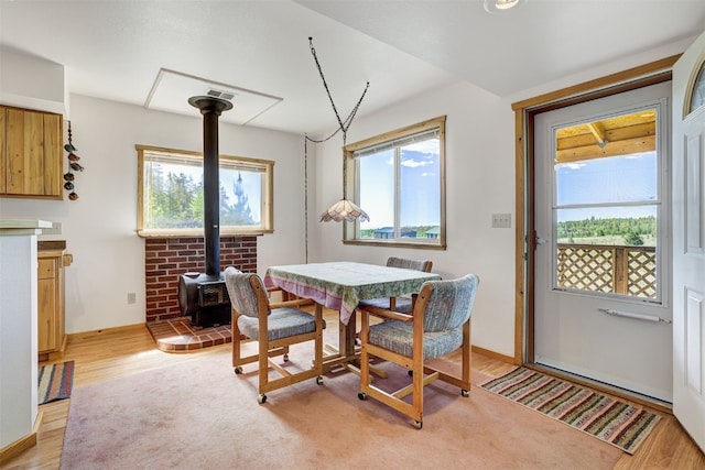 103 Foxtail Ct, Fairplay, CO 80440 - dining area featuring plenty of natural light, a wood stove, and light wood-style floors
