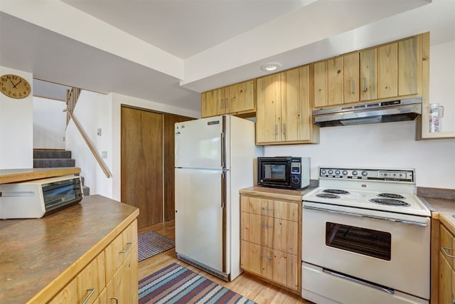 103 Foxtail Ct, Fairplay, CO 80440 - kitchen with white appliances, under cabinet range hood, light wood-style floors, and light brown cabinets