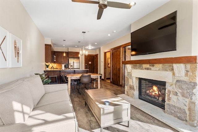 600 Columbine Rd Unit 5306, Breckenridge, CO 80424 - living area with wood finished floors, ceiling fan, a stone fireplace, a chandelier, and recessed lighting