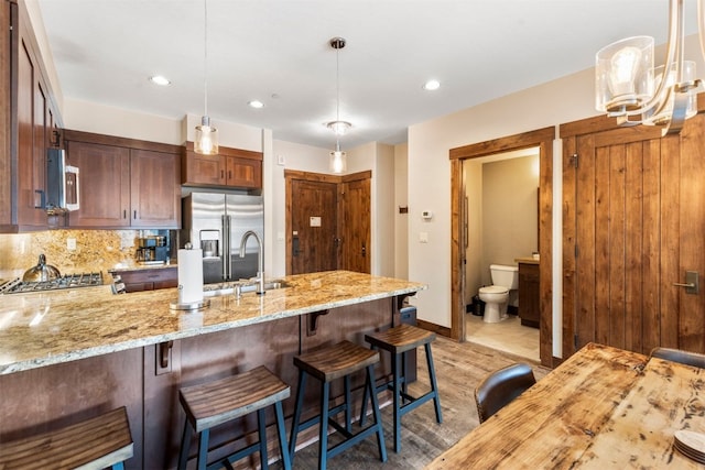 600 Columbine Rd Unit 5306, Breckenridge, CO 80424 - kitchen featuring a sink, appliances with stainless steel finishes, a peninsula, light stone counters, and recessed lighting