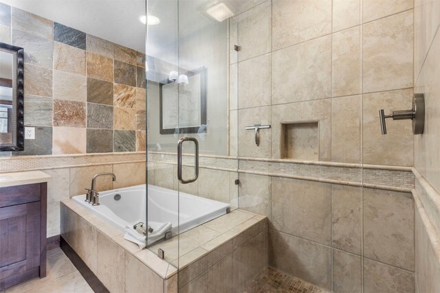 600 Columbine Rd Unit 5306, Breckenridge, CO 80424 - full bathroom with tile walls, a relaxing tiled tub, vanity, tiled shower, and tile patterned flooring