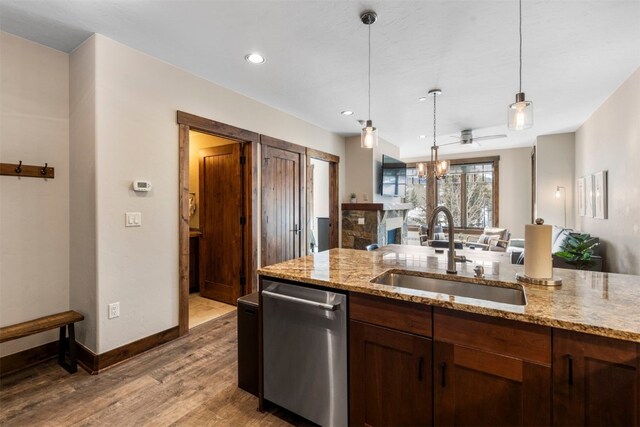 600 Columbine Rd Unit 5306, Breckenridge, CO 80424 - kitchen with a sink, stainless steel dishwasher, wood finished floors, hanging light fixtures, and light stone counters