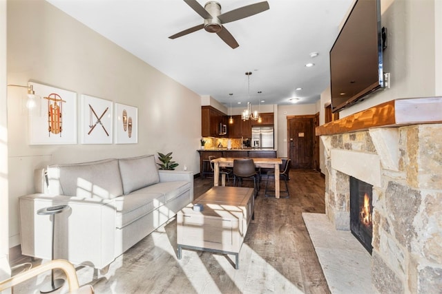 600 Columbine Rd Unit 5306, Breckenridge, CO 80424 - living area featuring a ceiling fan, wood finished floors, a stone fireplace, recessed lighting, and a chandelier