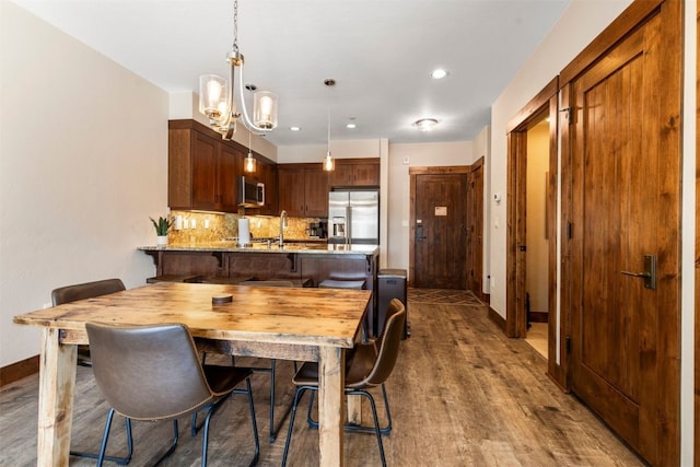 600 Columbine Rd Unit 5306, Breckenridge, CO 80424 - dining space with baseboards, a chandelier, wood finished floors, and recessed lighting