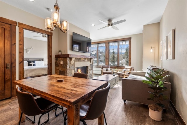 600 Columbine Rd Unit 5306, Breckenridge, CO 80424 - dining space featuring a stone fireplace, a ceiling fan, and wood finished floors