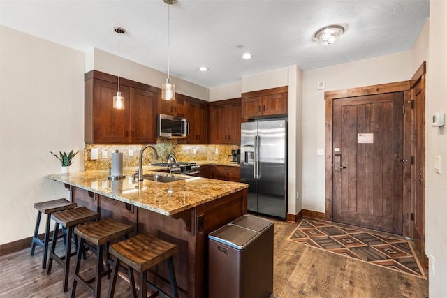 600 Columbine Rd Unit 5306, Breckenridge, CO 80424 - kitchen featuring appliances with stainless steel finishes, a sink, dark wood finished floors, a peninsula, and baseboards