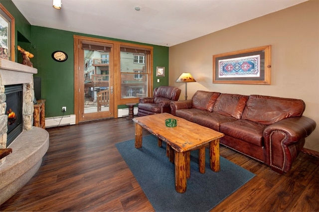 129 River Run Rd Unit 8040, Keystone, CO 80435 - living area with baseboard heating, wood finished floors, a stone fireplace, and baseboards