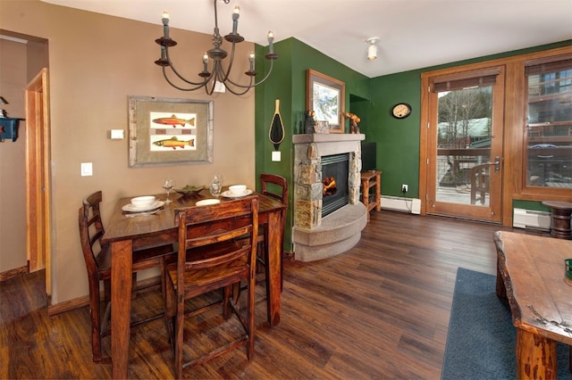 129 River Run Rd Unit 8040, Keystone, CO 80435 - dining space featuring a baseboard radiator, wood finished floors, a chandelier, baseboards, and a fireplace
