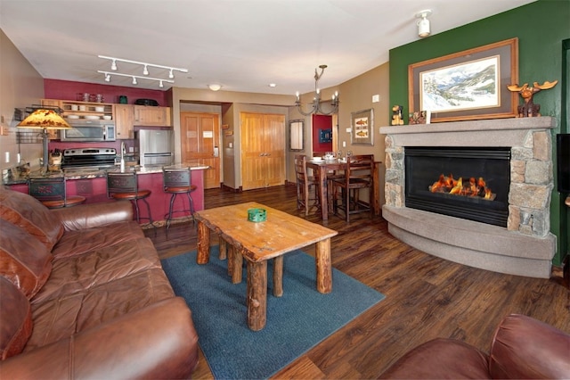 129 River Run Rd Unit 8040, Keystone, CO 80435 - living room with dark wood-style floors, a stone fireplace, and a chandelier