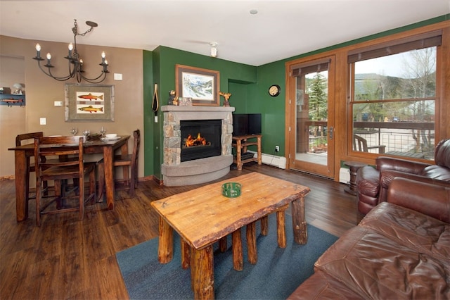 129 River Run Rd Unit 8040, Keystone, CO 80435 - living area featuring wood finished floors, a fireplace, a chandelier, a baseboard heating unit, and baseboards