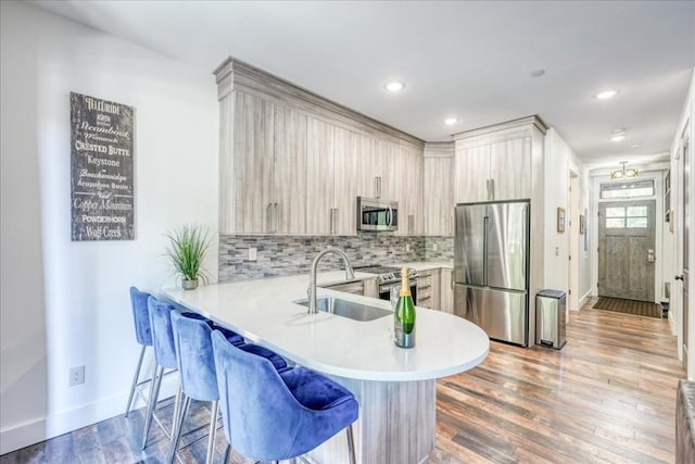 102 Lake Ridge Cir Unit 1888, Keystone, CO 80435 - kitchen with appliances with stainless steel finishes, light countertops, a kitchen breakfast bar, a peninsula, and tasteful backsplash