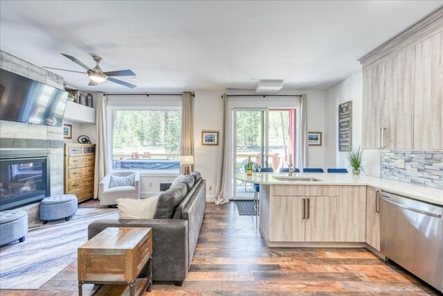 102 Lake Ridge Cir Unit 1888, Keystone, CO 80435 - kitchen with dishwasher, light brown cabinets, open floor plan, a peninsula, and light countertops