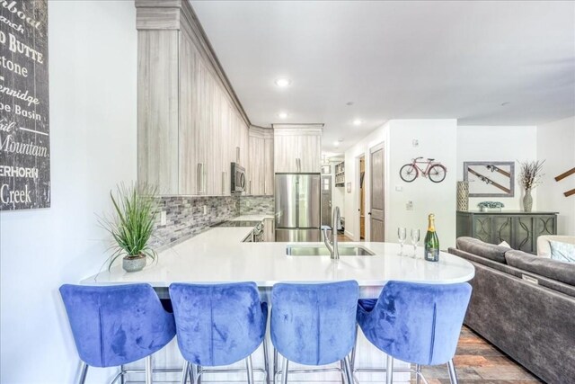 102 Lake Ridge Cir Unit 1888, Keystone, CO 80435 - kitchen with stainless steel appliances, light countertops, backsplash, a peninsula, and recessed lighting