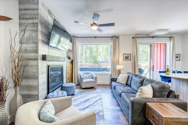 102 Lake Ridge Cir Unit 1888, Keystone, CO 80435 - living area with hardwood / wood-style flooring, a ceiling fan, and a glass covered fireplace