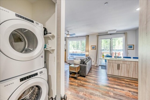 102 Lake Ridge Cir Unit 1888, Keystone, CO 80435 - laundry area featuring stacked washing machine and dryer, wood finished floors, and a ceiling fan