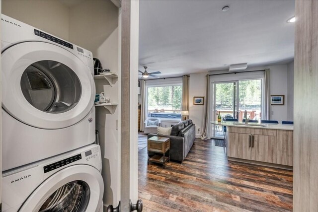 102 Lake Ridge Cir Unit 1888, Keystone, CO 80435 - laundry area featuring stacked washer and clothes dryer, dark wood-type flooring, and a ceiling fan