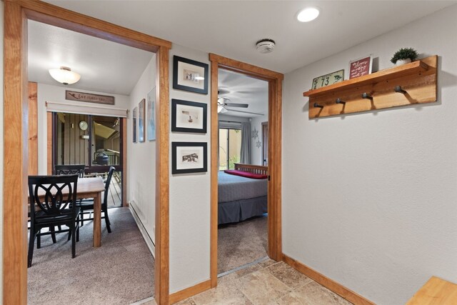 433 Wild Irishman Rd Unit 1039, Keystone, CO 80435 - hallway with a baseboard heating unit, baseboards, and light carpet