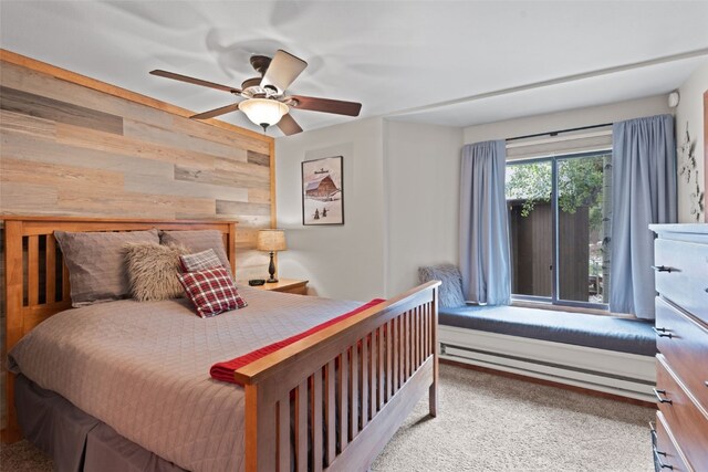 433 Wild Irishman Rd Unit 1039, Keystone, CO 80435 - carpeted bedroom featuring wood walls, a baseboard radiator, and a ceiling fan
