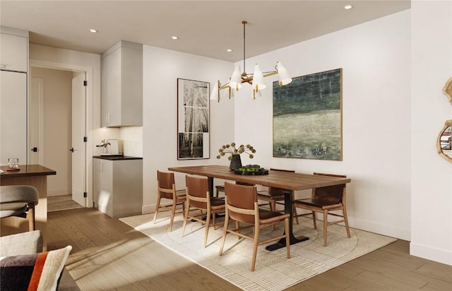 dining area featuring a notable chandelier and hardwood / wood-style flooring