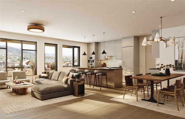 living room featuring a mountain view and light hardwood / wood-style floors