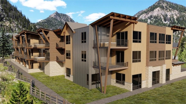 view of building exterior featuring a garage and a mountain view