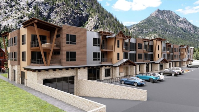 view of building exterior with an attached garage and a mountain view