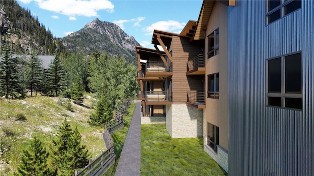 view of property with fence and a mountain view