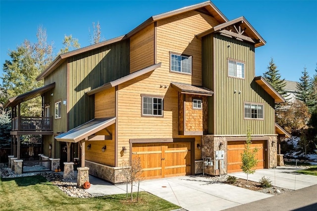 459 Willett Heights Ct, Steamboat Springs, CO 80487 - view of front of property featuring a garage, stone siding, driveway, and a balcony