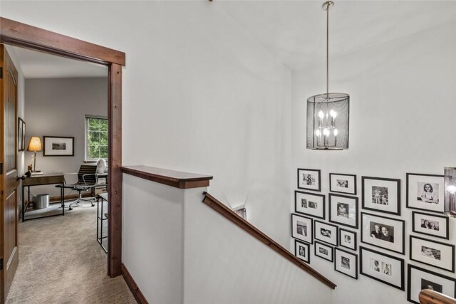 459 Willett Heights Ct, Steamboat Springs, CO 80487 - hall with an upstairs landing, carpet flooring, a chandelier, a desk, and baseboards