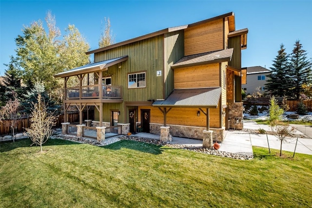 459 Willett Heights Ct, Steamboat Springs, CO 80487 - back of house with a balcony, stone siding, and a patio area