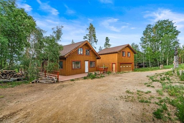 243 Lone Hand Way, Breckenridge, CO 80424 - rear view of property with dirt driveway and board and batten siding