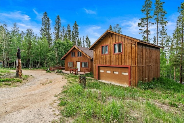 243 Lone Hand Way, Breckenridge, CO 80424 - view of front of home with board and batten siding, driveway, and an attached garage