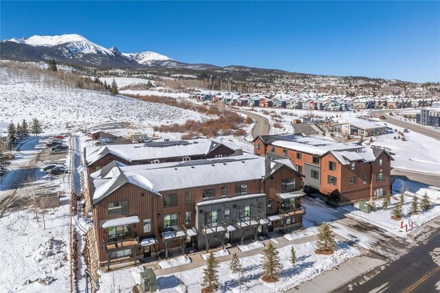 snowy aerial view featuring a mountain view