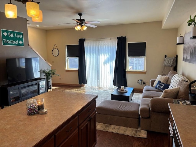2379 Abbey Ct Unit 3, Steamboat Springs, CO 80487 - living room featuring a ceiling fan, dark wood-type flooring, and baseboards