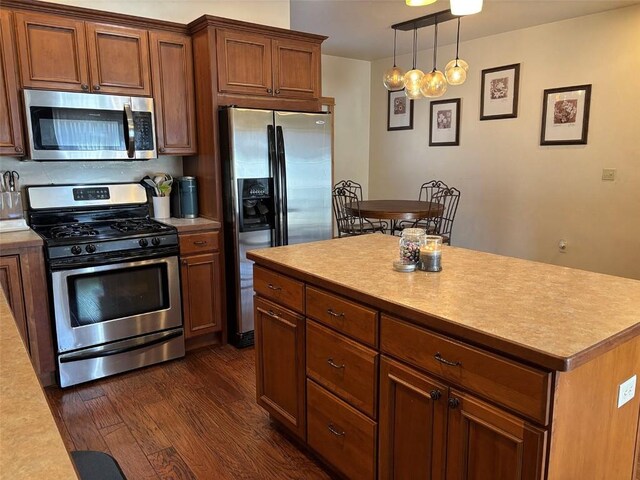 2379 Abbey Ct Unit 3, Steamboat Springs, CO 80487 - kitchen with appliances with stainless steel finishes, light countertops, dark wood-style floors, and brown cabinets