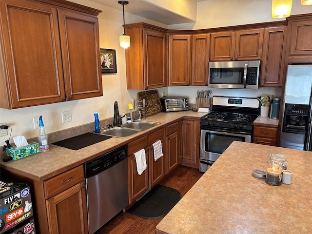 2379 Abbey Ct Unit 3, Steamboat Springs, CO 80487 - kitchen featuring appliances with stainless steel finishes, a sink, dark wood-type flooring, and light countertops