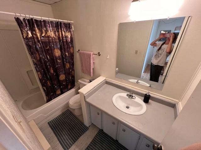 full bathroom with toilet, shower / bath combo with shower curtain, and vanity