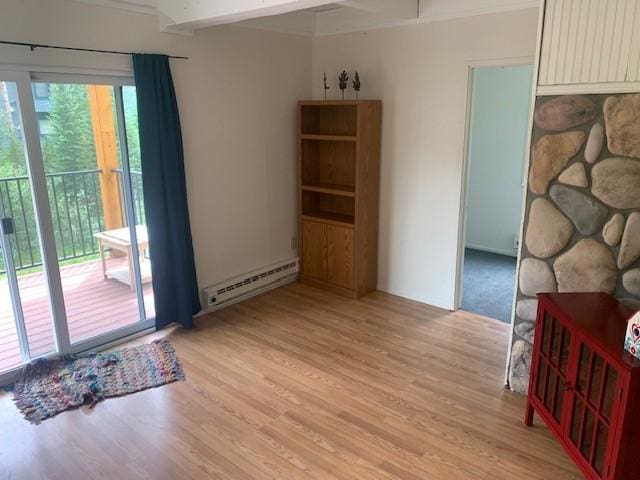 dining room with baseboard heating and light wood-style floors
