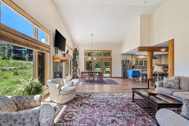 12 Raindance Trl, Dillon, CO 80435 - living area with high vaulted ceiling, wood finished floors, healthy amount of natural light, and a tiled fireplace