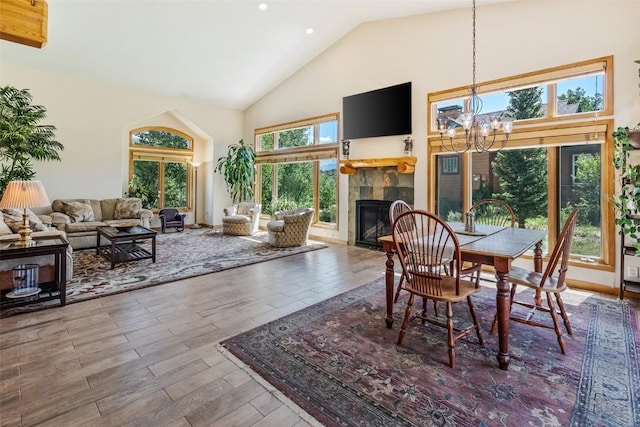 12 Raindance Trl, Dillon, CO 80435 - dining space with high vaulted ceiling, a chandelier, wood finished floors, a tiled fireplace, and recessed lighting