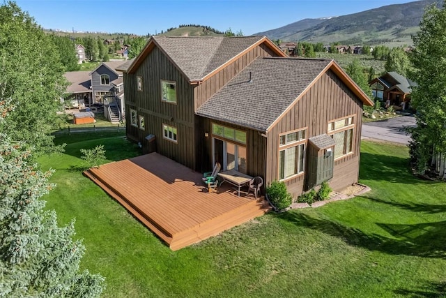 12 Raindance Trl, Dillon, CO 80435 - rear view of property with a deck with mountain view, roof with shingles, board and batten siding, and a yard