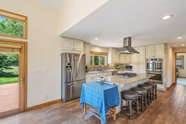 12 Raindance Trl, Dillon, CO 80435 - kitchen featuring stainless steel appliances, wall chimney range hood, cream cabinets, plenty of natural light, and recessed lighting